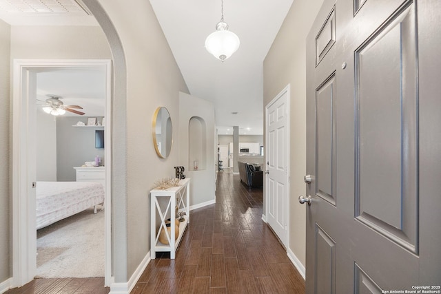 13014 Essen, Helotes, TX 78023 - hallway with dark wood-type flooring, baseboards, and arched walkways