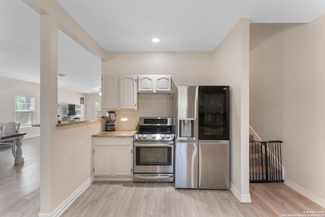 8608 S Foster Rd, San Antonio, TX 78222 - kitchen with appliances with stainless steel finishes, light wood-style floors, white cabinetry, and baseboards