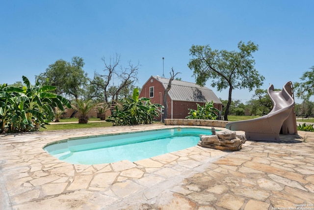 8608 S Foster Rd, San Antonio, TX 78222 - outdoor pool with a water slide, an outdoor structure, and a patio area