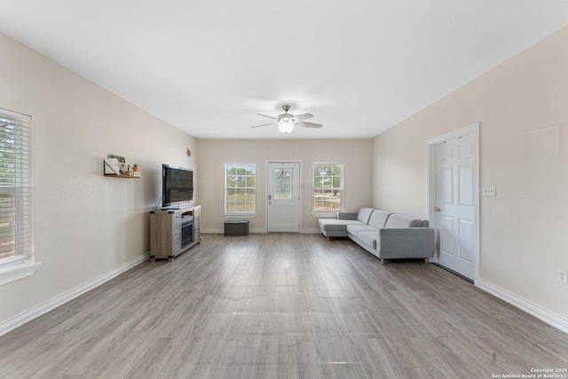 8608 S Foster Rd, San Antonio, TX 78222 - living room featuring a ceiling fan, light wood finished floors, and baseboards