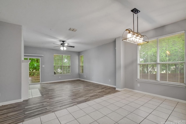 1947 Walter Raleigh, Windcrest, TX 78239 - empty room featuring a ceiling fan, wood finished floors, a chandelier, and baseboards