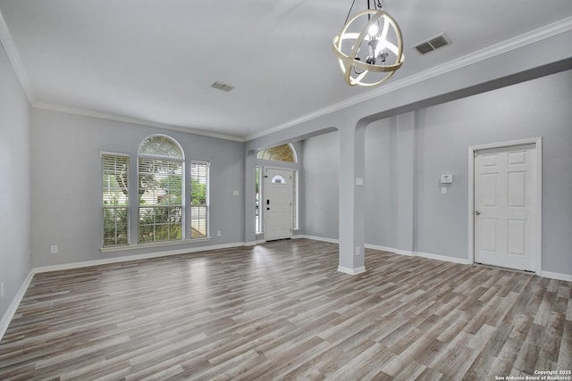 1947 Walter Raleigh, Windcrest, TX 78239 - foyer featuring a chandelier, wood finished floors, crown molding, baseboards, and arched walkways