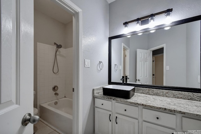1947 Walter Raleigh, Windcrest, TX 78239 - full bath featuring vanity, bathtub / shower combination, toilet, tile patterned floors, and a textured wall