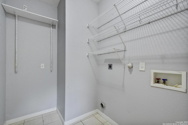 1947 Walter Raleigh, Windcrest, TX 78239 - laundry room with electric dryer hookup, hookup for a washing machine, baseboards, and tile patterned floors