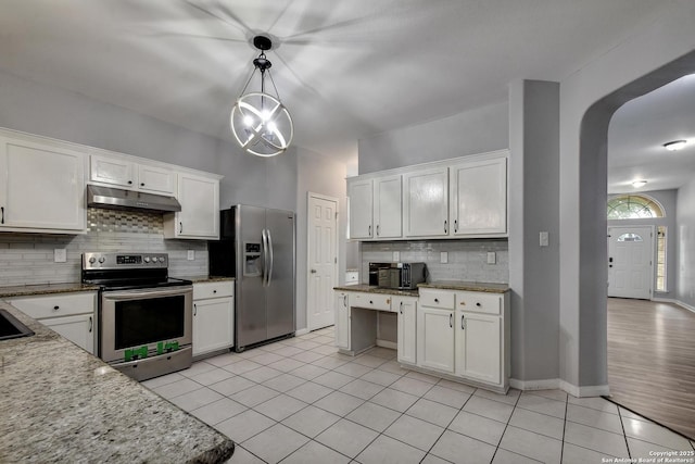 1947 Walter Raleigh, Windcrest, TX 78239 - kitchen featuring stainless steel appliances, under cabinet range hood, backsplash, light tile patterned floors, and white cabinets
