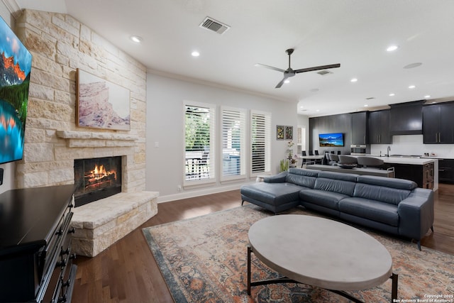 314 Regent Cir, Shavano Park, TX 78231 - living room with crown molding, a stone fireplace, wood finished floors, a ceiling fan, and recessed lighting