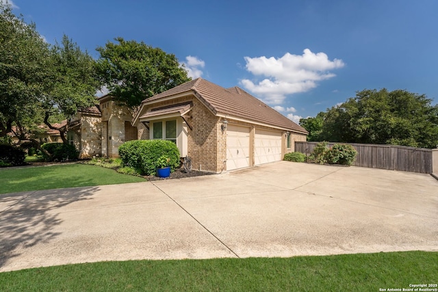 314 Regent Cir, Shavano Park, TX 78231 - view of home's exterior with brick siding, an attached garage, and concrete driveway