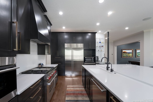 314 Regent Cir, Shavano Park, TX 78231 - kitchen featuring high end appliances, a sink, crown molding, light countertops, and dark wood-style flooring