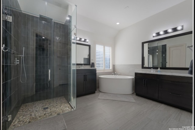 314 Regent Cir, Shavano Park, TX 78231 - full bath featuring a shower stall, two vanities, a soaking tub, vaulted ceiling, and tile walls