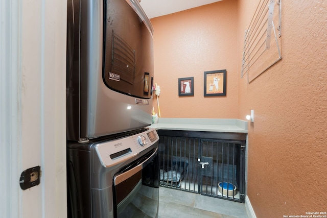 314 Regent Cir, Shavano Park, TX 78231 - washroom with stacked washing machine and dryer, a textured wall, and tile patterned flooring