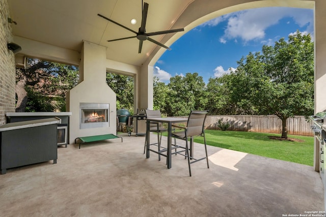 314 Regent Cir, Shavano Park, TX 78231 - view of patio / terrace with a large fireplace, ceiling fan, grilling area, and outdoor dining space