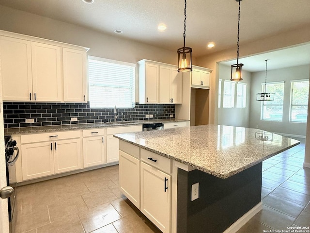 2035 Tillman Park, San Antonio, TX 78253 - kitchen with decorative backsplash, a center island, white cabinets, recessed lighting, and light stone countertops