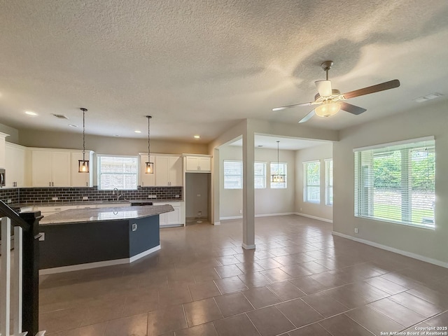 2035 Tillman Park, San Antonio, TX 78253 - kitchen with tasteful backsplash, healthy amount of natural light, a ceiling fan, white cabinetry, and recessed lighting