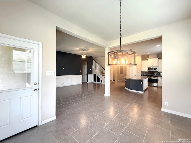2035 Tillman Park, San Antonio, TX 78253 - kitchen featuring stainless steel appliances, decorative backsplash, ceiling fan, a kitchen island, and hanging light fixtures