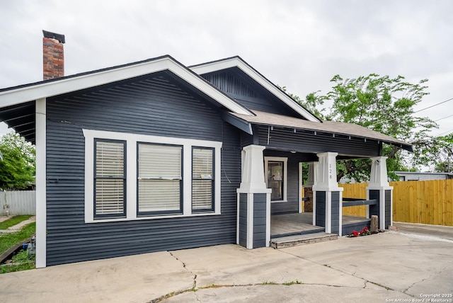 128 Blanco, San Antonio, TX 78212 - view of property exterior featuring a porch, a patio, and a chimney