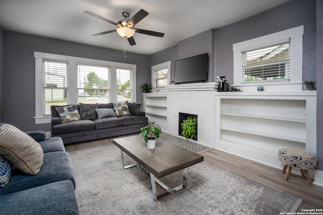 128 Blanco, San Antonio, TX 78212 - living room with wood finished floors, ceiling fan, and a brick fireplace