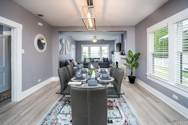 128 Blanco, San Antonio, TX 78212 - dining room with ceiling fan, light wood-type flooring, baseboards, and a fireplace