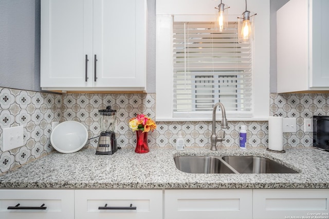 128 Blanco, San Antonio, TX 78212 - kitchen featuring a sink, white cabinetry, tasteful backsplash, and light stone counters