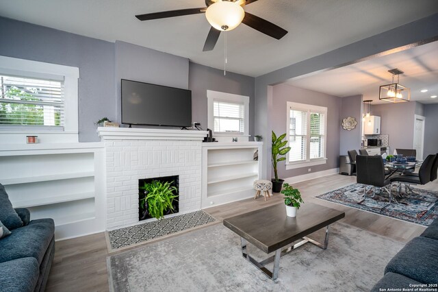 128 Blanco, San Antonio, TX 78212 - living room with wood finished floors, a ceiling fan, a fireplace, and baseboards