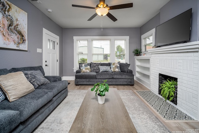 128 Blanco, San Antonio, TX 78212 - living area with ceiling fan, light wood finished floors, a brick fireplace, and baseboards