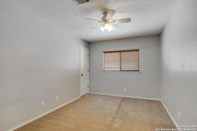 17214 Irongate Rail, San Antonio, TX 78247 - spare room featuring ceiling fan, a textured ceiling, light carpet, and baseboards