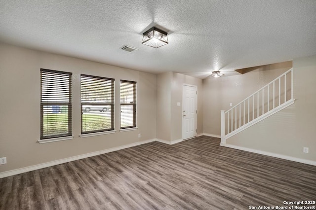 17214 Irongate Rail, San Antonio, TX 78247 - entryway with wood finished floors, a textured ceiling, stairs, and baseboards