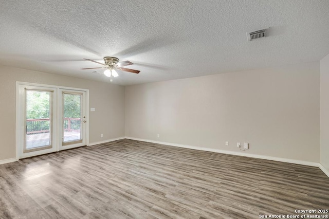 17214 Irongate Rail, San Antonio, TX 78247 - unfurnished room with a ceiling fan, wood finished floors, a textured ceiling, and baseboards
