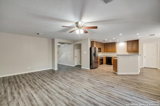 17214 Irongate Rail, San Antonio, TX 78247 - unfurnished living room featuring light wood-type flooring, a textured ceiling, ceiling fan, recessed lighting, and baseboards