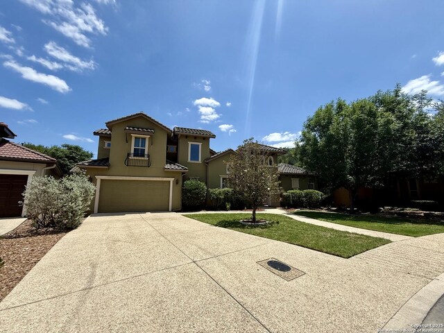 1410 Melanie, San Antonio, TX 78258 - mediterranean / spanish-style home featuring concrete driveway, a garage, a tiled roof, and stucco siding
