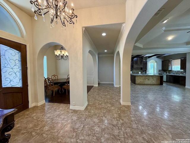 1410 Melanie, San Antonio, TX 78258 - foyer featuring a chandelier, arched walkways, and tile patterned floors