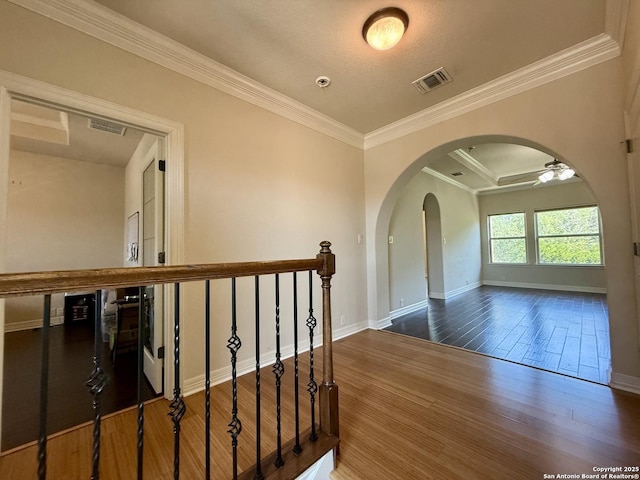 1410 Melanie, San Antonio, TX 78258 - hallway featuring arched walkways, wood finished floors, crown molding, baseboards, and an upstairs landing