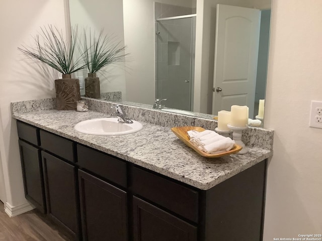 7502 Anchor Cyn, San Antonio, TX 78252 - bathroom with vanity, an enclosed shower, and wood finished floors