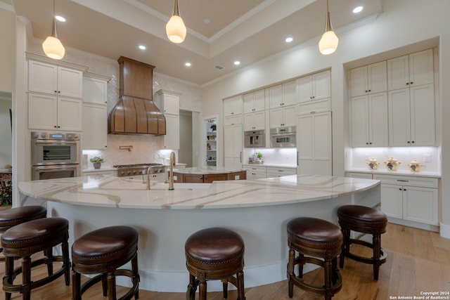 507 Arthur Ct, Spring Branch, TX 78070 - kitchen featuring a large island, ornamental molding, a sink, a kitchen breakfast bar, and backsplash