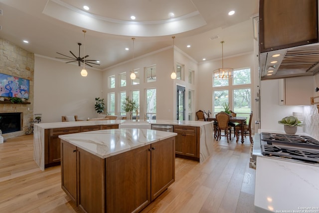 507 Arthur Ct, Spring Branch, TX 78070 - kitchen featuring ornamental molding, a large island, brown cabinetry, open floor plan, and a fireplace