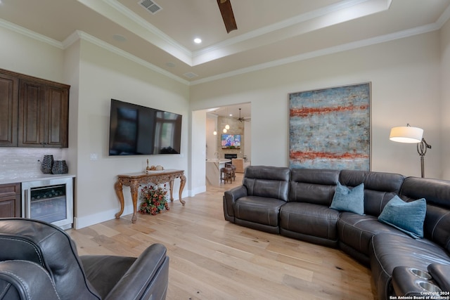 507 Arthur Ct, Spring Branch, TX 78070 - living room with beverage cooler, a raised ceiling, light wood finished floors, ornamental molding, and baseboards