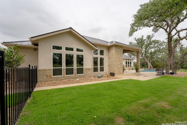 507 Arthur Ct, Spring Branch, TX 78070 - back of house featuring a standing seam roof, stone siding, metal roof, and stucco siding