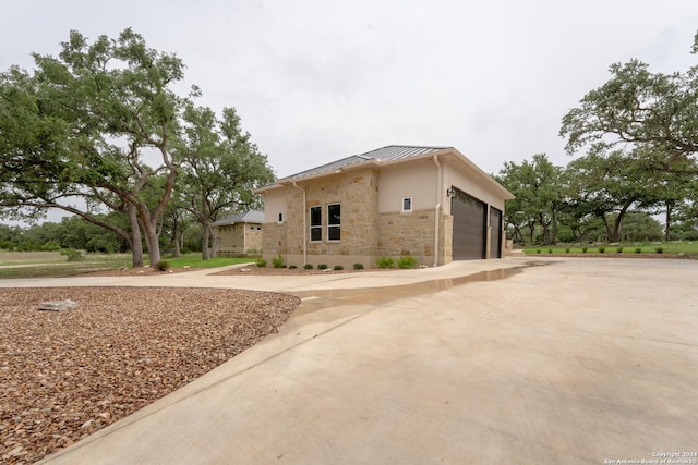 507 Arthur Ct, Spring Branch, TX 78070 - view of front facade with a standing seam roof, stone siding, concrete driveway, stucco siding, and metal roof
