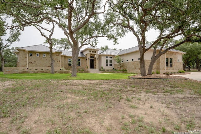 507 Arthur Ct, Spring Branch, TX 78070 - view of front facade with stone siding, a standing seam roof, a front lawn, and metal roof