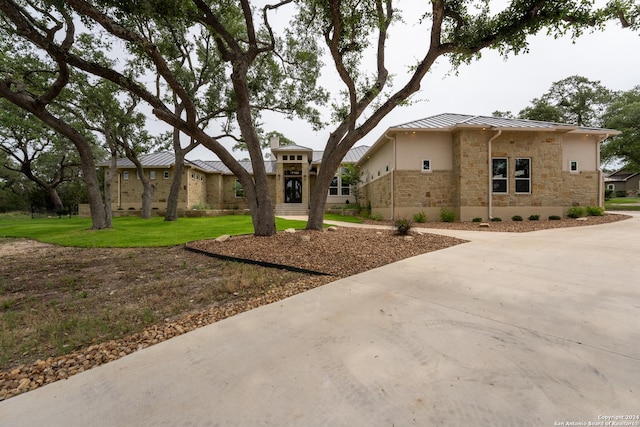 507 Arthur Ct, Spring Branch, TX 78070 - view of front facade featuring a standing seam roof, stone siding, metal roof, driveway, and stucco siding