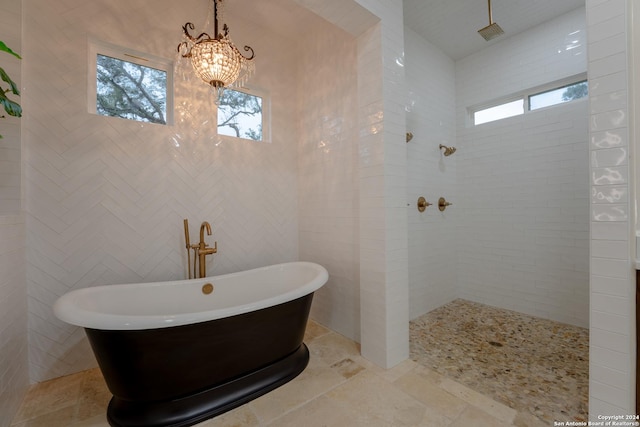 507 Arthur Ct, Spring Branch, TX 78070 - bathroom featuring plenty of natural light, a soaking tub, a walk in shower, and tile walls