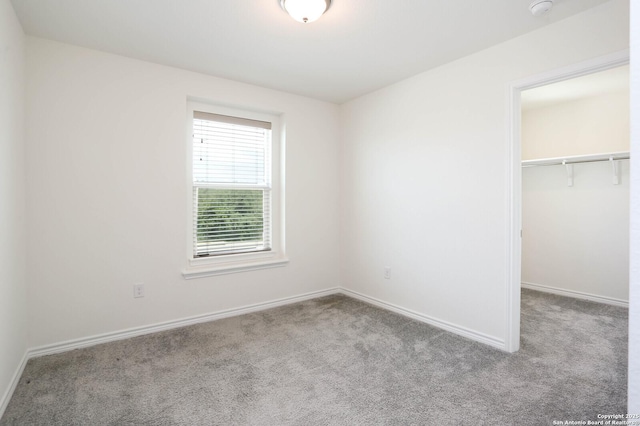 2006 Prometheus Cv, San Antonio, TX 78245 - unfurnished bedroom with carpet, a walk in closet, and baseboards