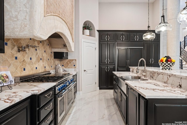 3 Benchwood Cir, San Antonio, TX 78248 - kitchen with high quality appliances, a towering ceiling, light marble finish flooring, decorative backsplash, and dark cabinets