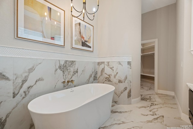 3 Benchwood Cir, San Antonio, TX 78248 - bathroom featuring vanity, marble tiled flooring, a soaking tub, a walk in closet, and a chandelier