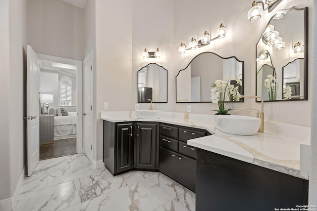 3 Benchwood Cir, San Antonio, TX 78248 - ensuite bathroom with marble finish flooring, double vanity, baseboards, and a towering ceiling