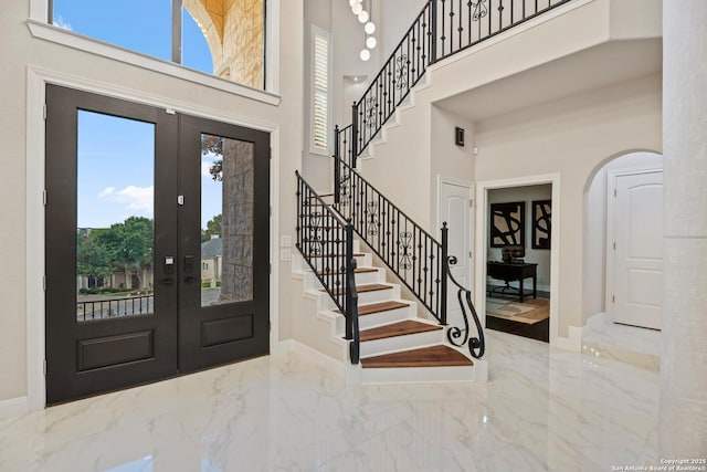 3 Benchwood Cir, San Antonio, TX 78248 - foyer featuring a towering ceiling, marble tiled floors, arched walkways, stairway, and french doors