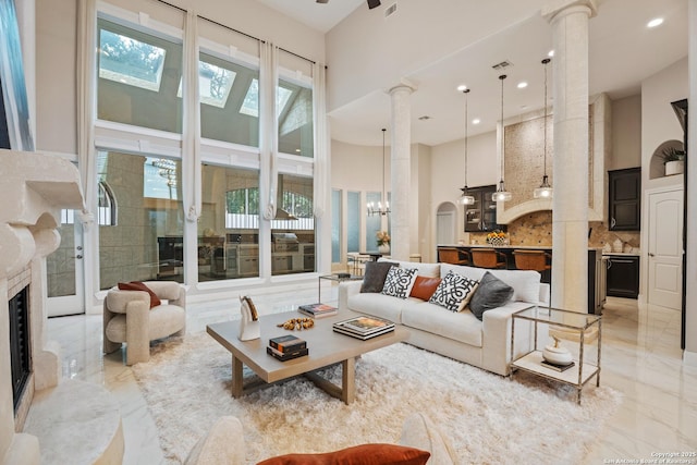3 Benchwood Cir, San Antonio, TX 78248 - living area with a high ceiling, light marble finish flooring, ornate columns, a chandelier, and recessed lighting