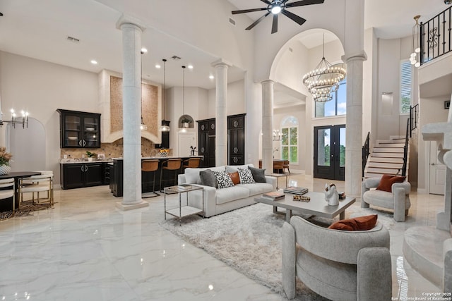 3 Benchwood Cir, San Antonio, TX 78248 - living area with a towering ceiling, ornate columns, light marble finish flooring, a ceiling fan, and a chandelier