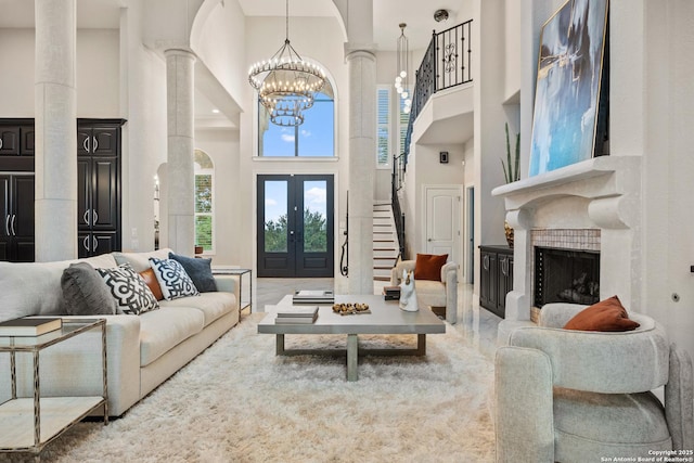 3 Benchwood Cir, San Antonio, TX 78248 - living area with a high ceiling, decorative columns, a chandelier, a fireplace, and french doors