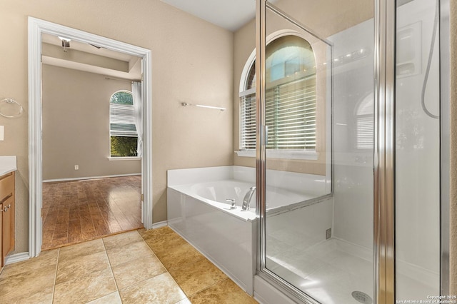 6218 Ozona Ml, San Antonio, TX 78253 - full bathroom featuring vanity, a bath, a stall shower, and baseboards