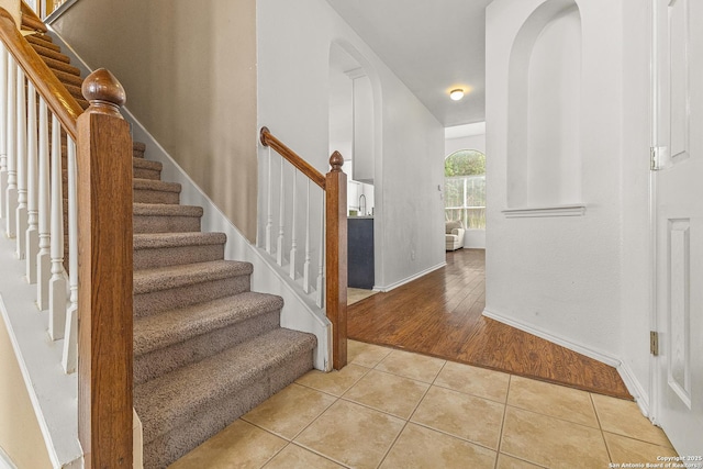 6218 Ozona Ml, San Antonio, TX 78253 - entrance foyer with light tile patterned flooring, stairs, baseboards, and arched walkways